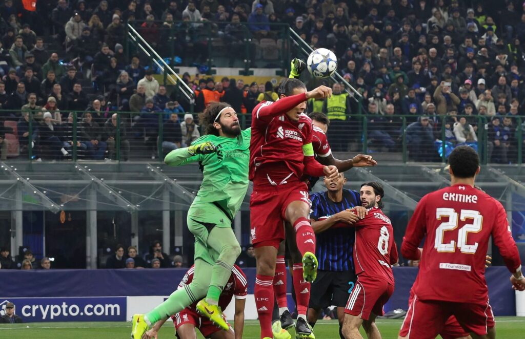 Alisson Becker punches the ball ahead of Virgil van Dijk