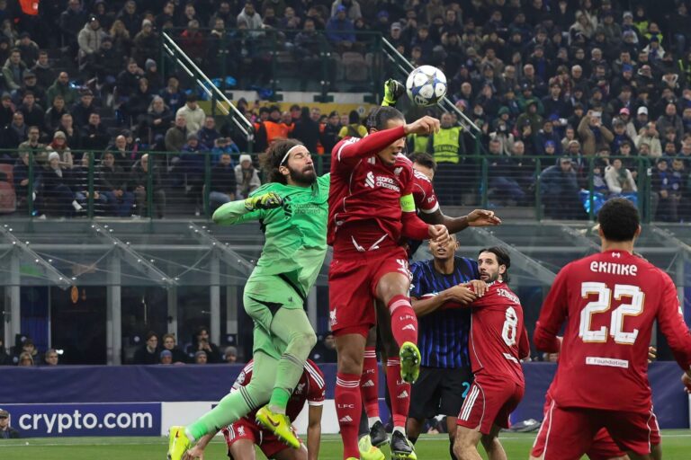 Alisson Becker punches the ball ahead of Virgil van Dijk