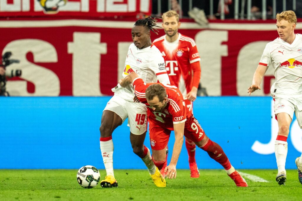 RB Leipzig winger Yan Diomande grapples with Bayern Munich's Harry Kane