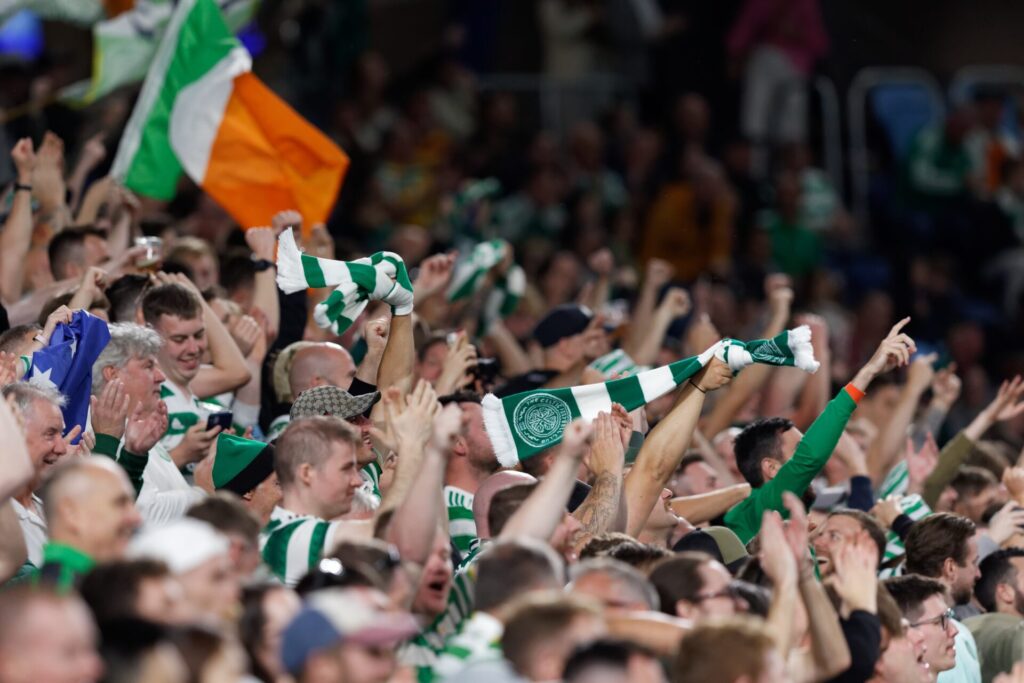 Celtic FC supporters waving flags in crowd