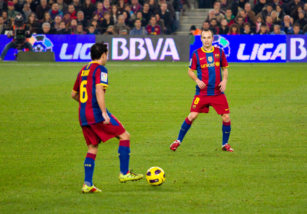 Xavi Hernandez and Andres Iniesta playing for Barcelona