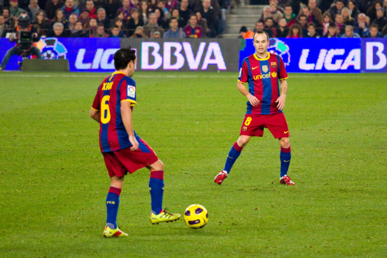 Xavi Hernandez and Andres Iniesta playing for Barcelona